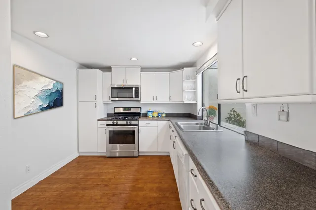 a view of a kitchen with a refrigerator a sink and dishwasher