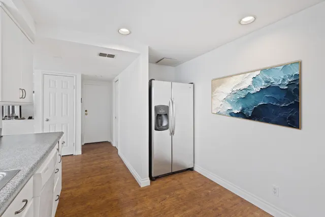 a large bed sitting in a bedroom next to a window