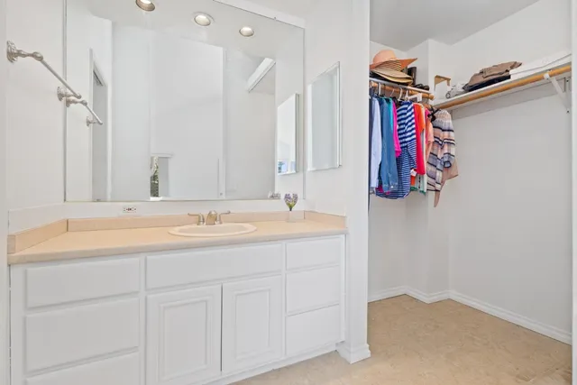 a bathroom with a double vanity sink toilet mirror and shower