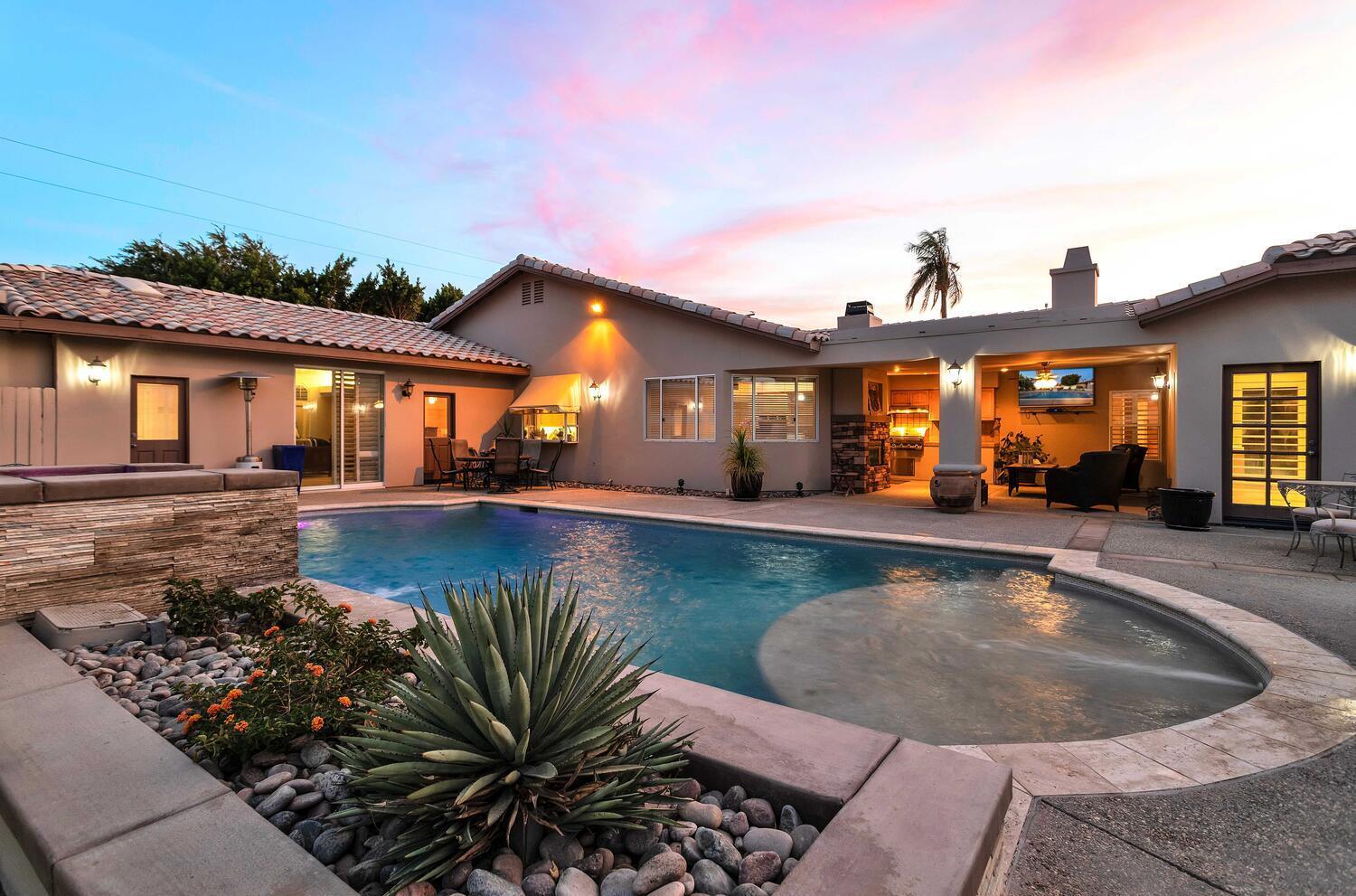 a view of a house with swimming pool and porch