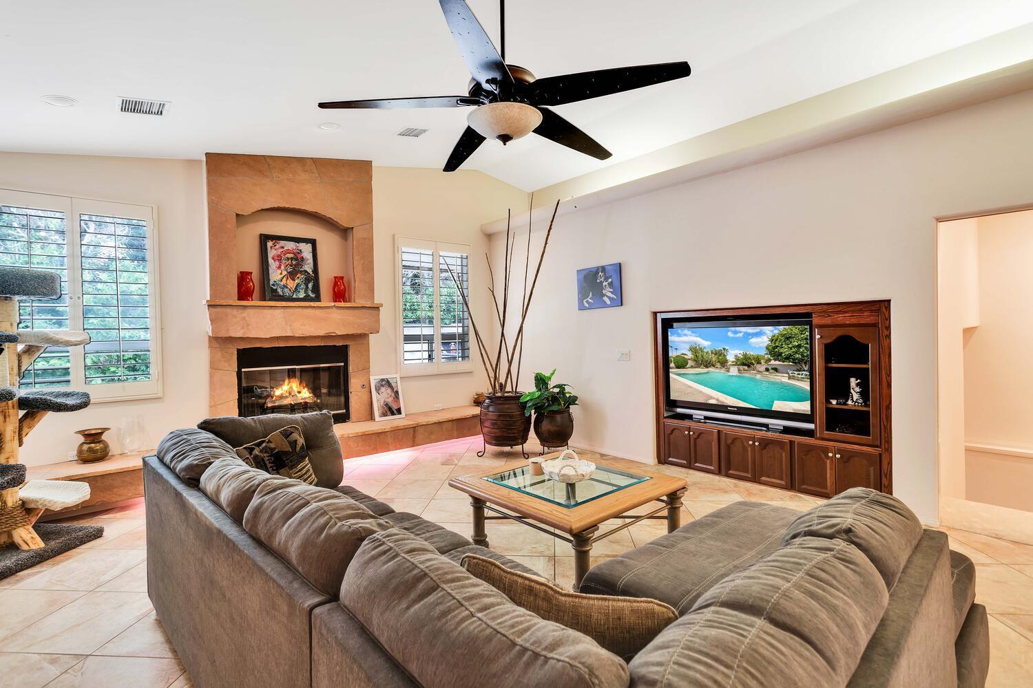 43920 Culebra Lane Bermuda Dunes, CA 92203 - Photo 12 of 66 a living room with furniture a flat screen tv and a fireplace