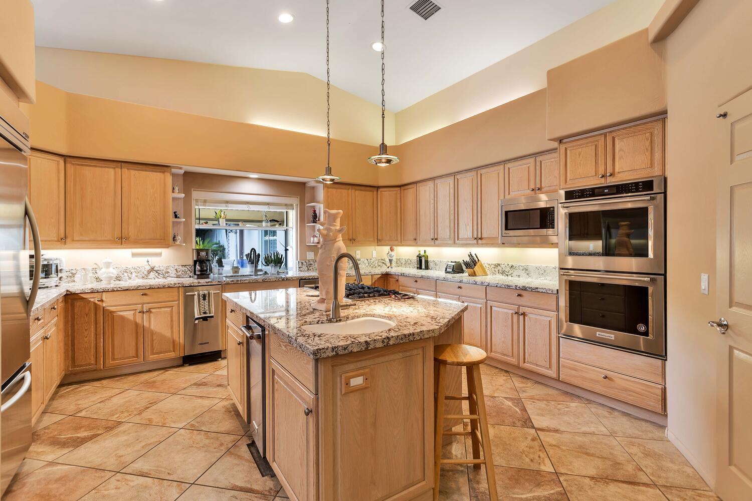 43920 Culebra Lane Bermuda Dunes, CA 92203 - Photo 14 of 66 a kitchen with stainless steel appliances granite countertop a sink counter space cabinets and a counter top space