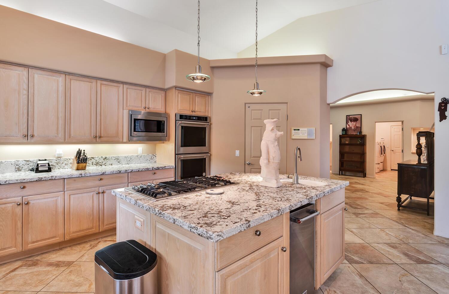43920 Culebra Lane Bermuda Dunes, CA 92203 - Photo 16 of 66 a kitchen with stainless steel appliances kitchen island granite countertop a sink a stove and cabinets