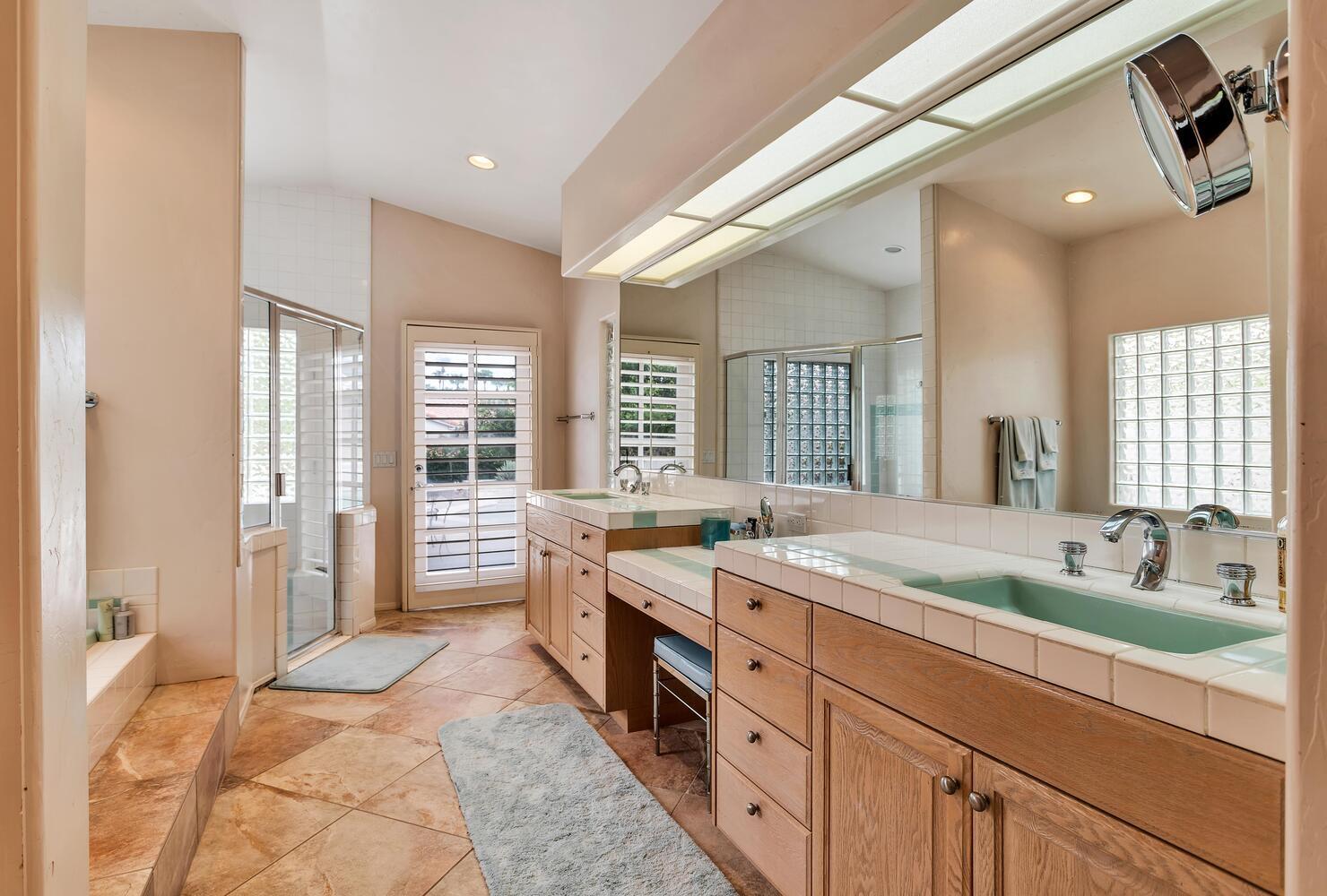 43920 Culebra Lane Bermuda Dunes, CA 92203 - Photo 26 of 66 a spacious bathroom with a granite countertop double vanity sink a mirror and a bathtub