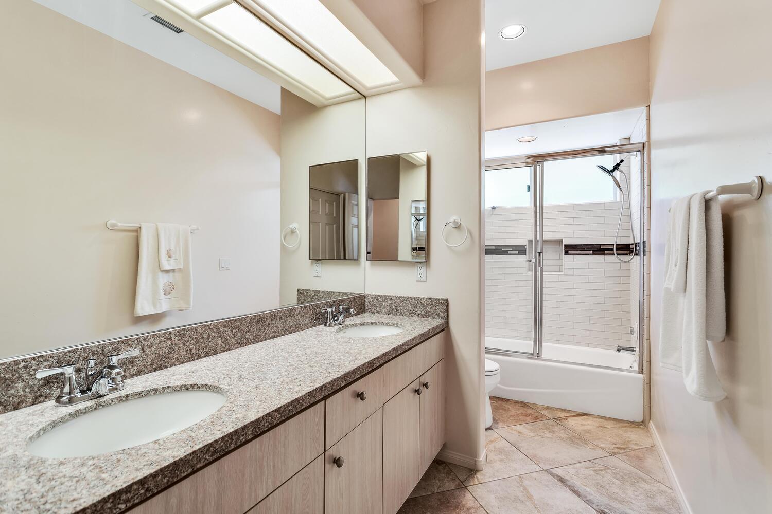 43920 Culebra Lane Bermuda Dunes, CA 92203 - Photo 41 of 66 a bathroom with a granite countertop double vanity sink a mirror and a bathtub