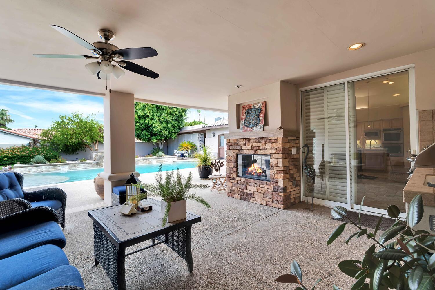 43920 Culebra Lane Bermuda Dunes, CA 92203 - Photo 45 of 66 a living room with furniture a fireplace and a floor to ceiling window