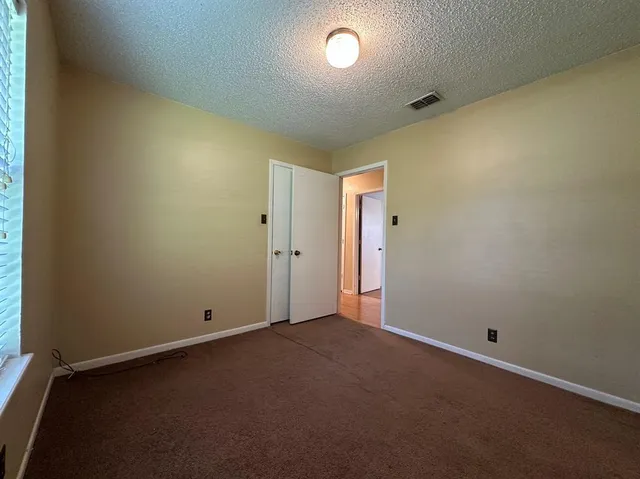 an empty room with a empty space and a window