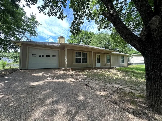front view of a house with a trees