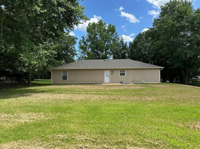 a front view of house with yard and trees