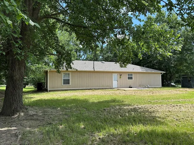 a house with a yard and a large tree