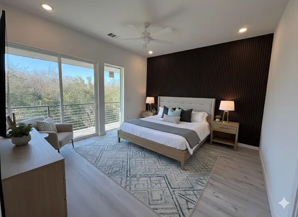 a bedroom with a large bed and a large window