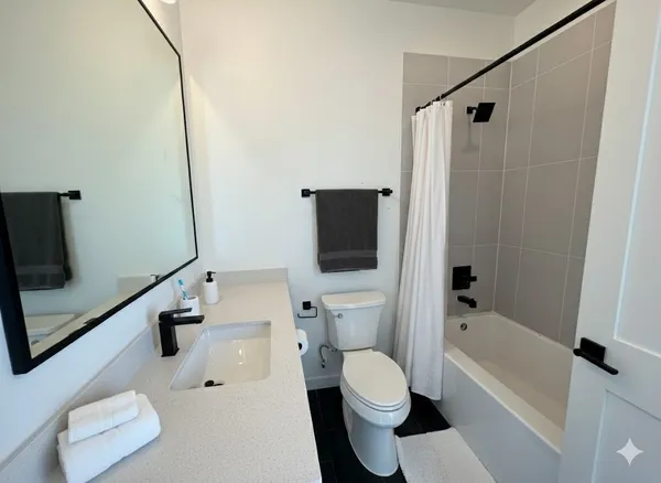 a bathroom with a toilet a sink and bathtub