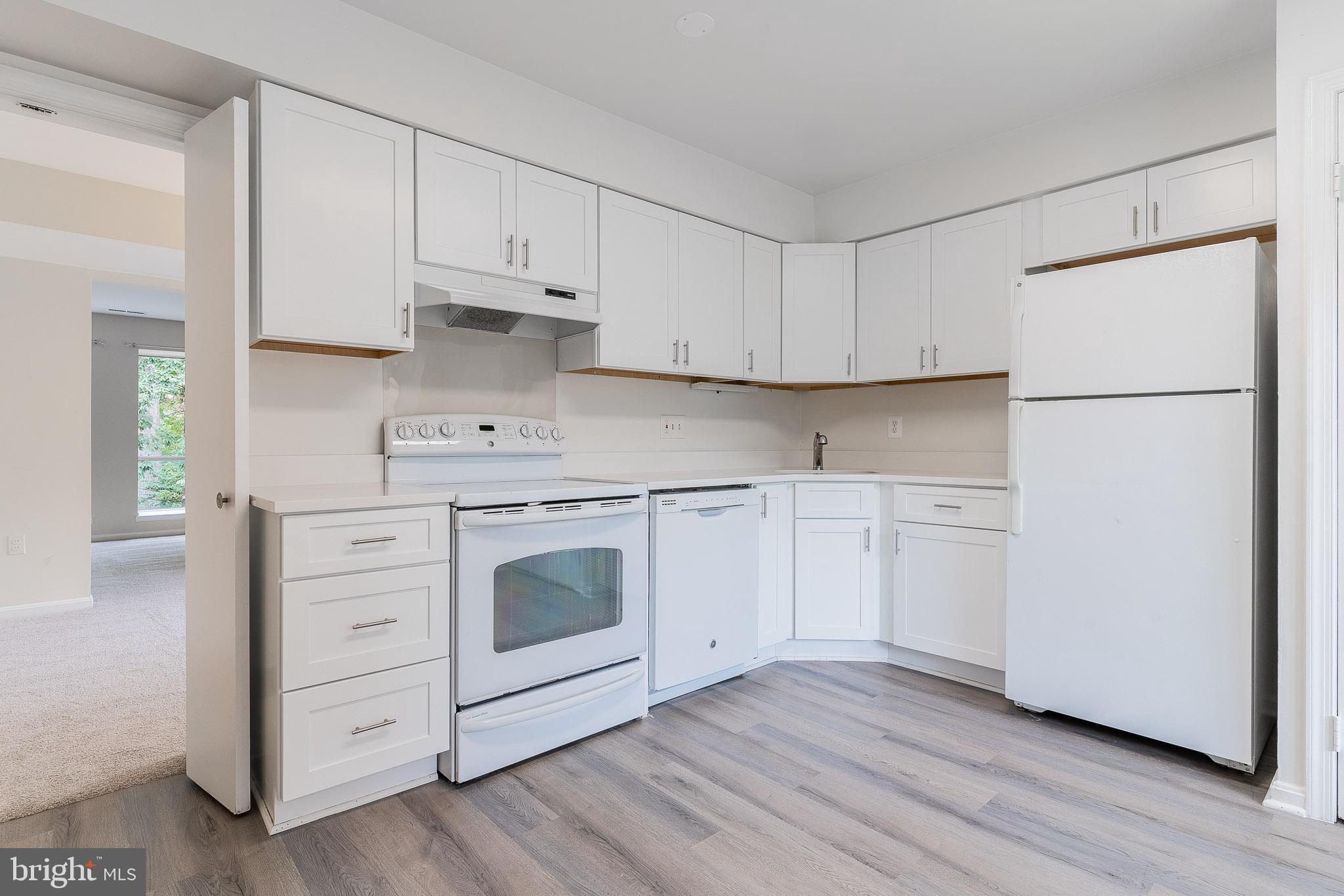 3840 Persimmon Circle Fairfax, VA 22031 - Photo 6 of 25 a kitchen with white cabinets white stainless steel appliances and sink