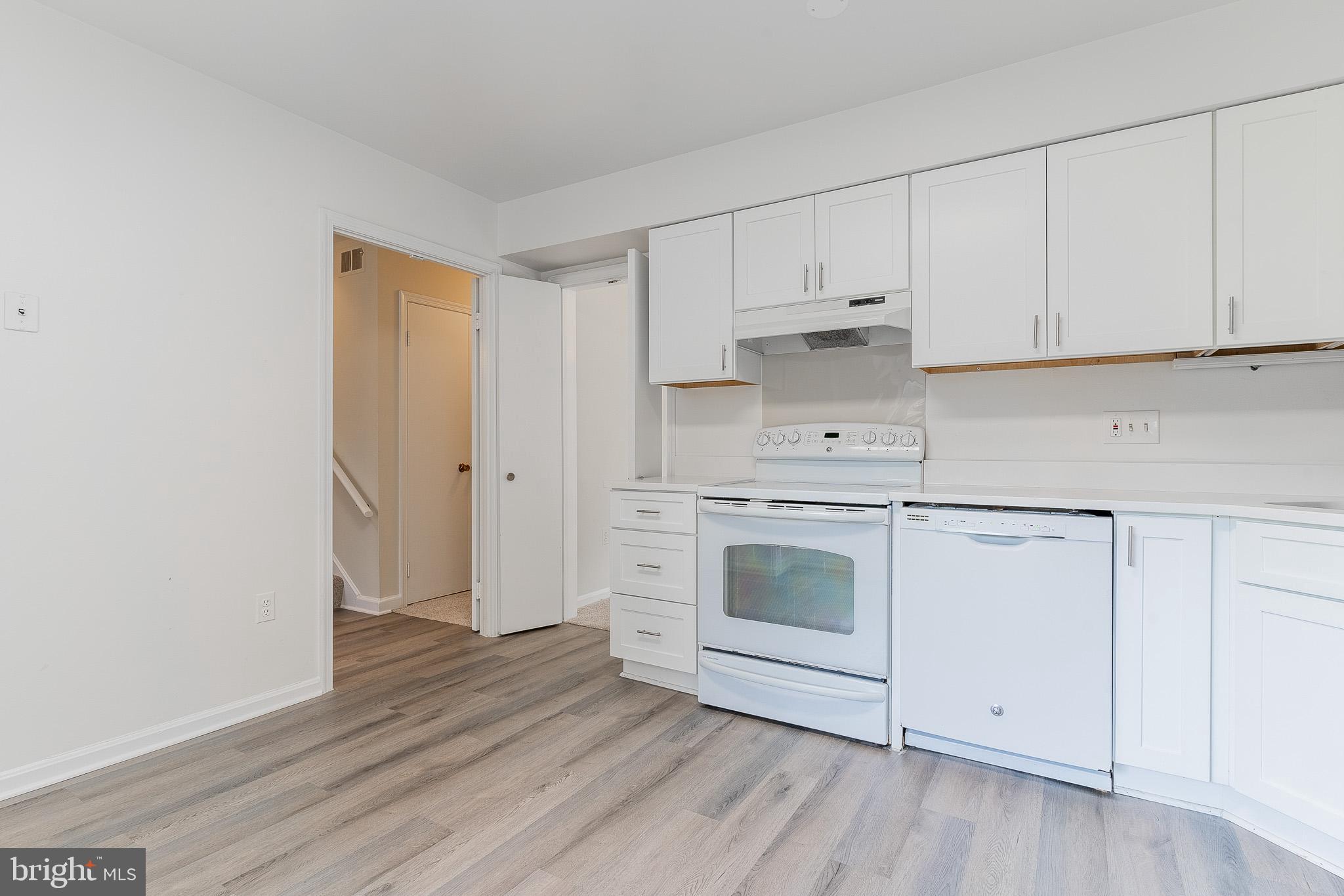 3840 Persimmon Circle Fairfax, VA 22031 - Photo 7 of 25 a kitchen with white cabinets and white appliances