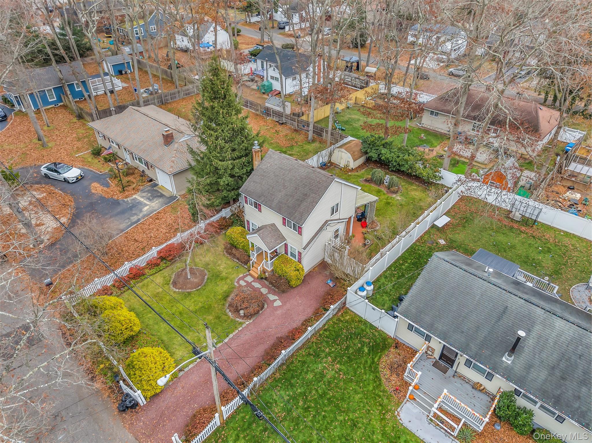 103 Wauwepex Trail Ridge, NY 11961 - Photo 1 of 25 an aerial view of a house with a garden and swimming pool