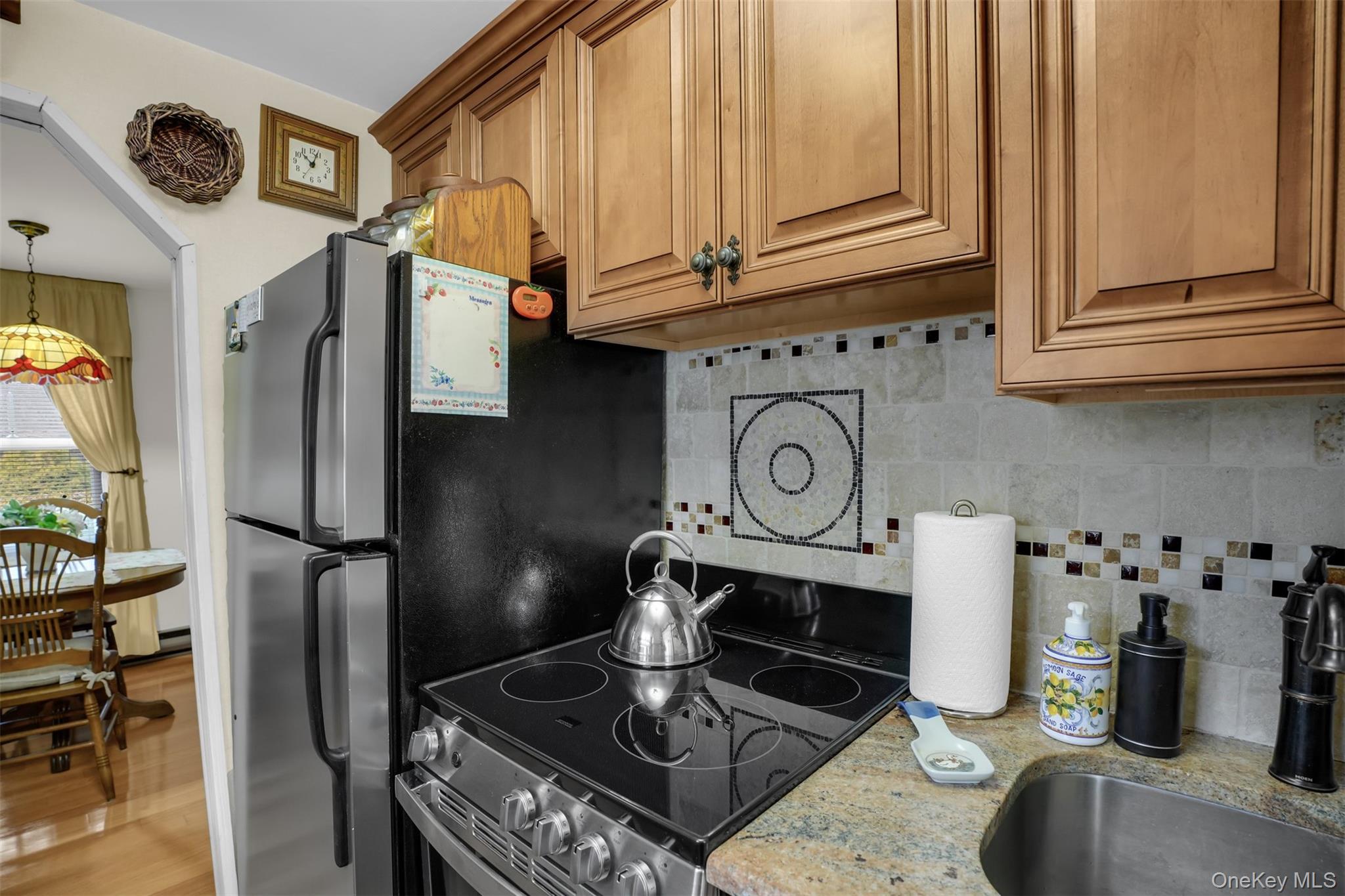 103 Wauwepex Trail Ridge, NY 11961 - Photo 13 of 25 a kitchen with stainless steel appliances granite countertop a refrigerator and a stove top oven