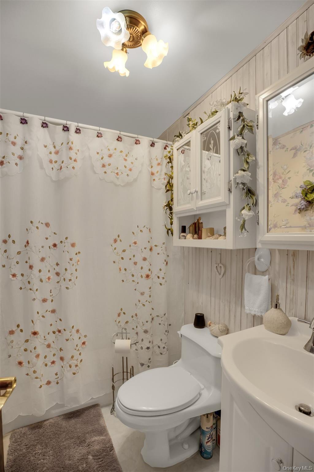 103 Wauwepex Trail Ridge, NY 11961 - Photo 15 of 25 a bathroom with a toilet sink and mirror