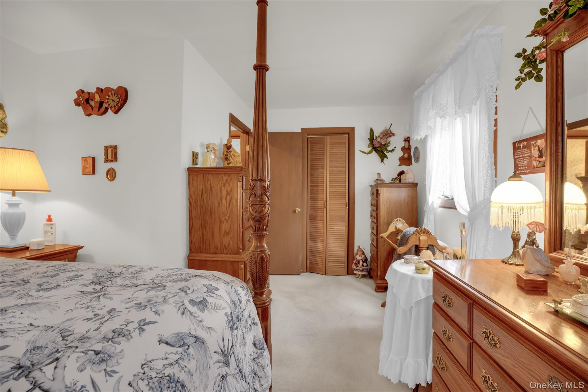 103 Wauwepex Trail Ridge, NY 11961 - Photo 20 of 25 a bedroom with a bed and a dresser next to a window