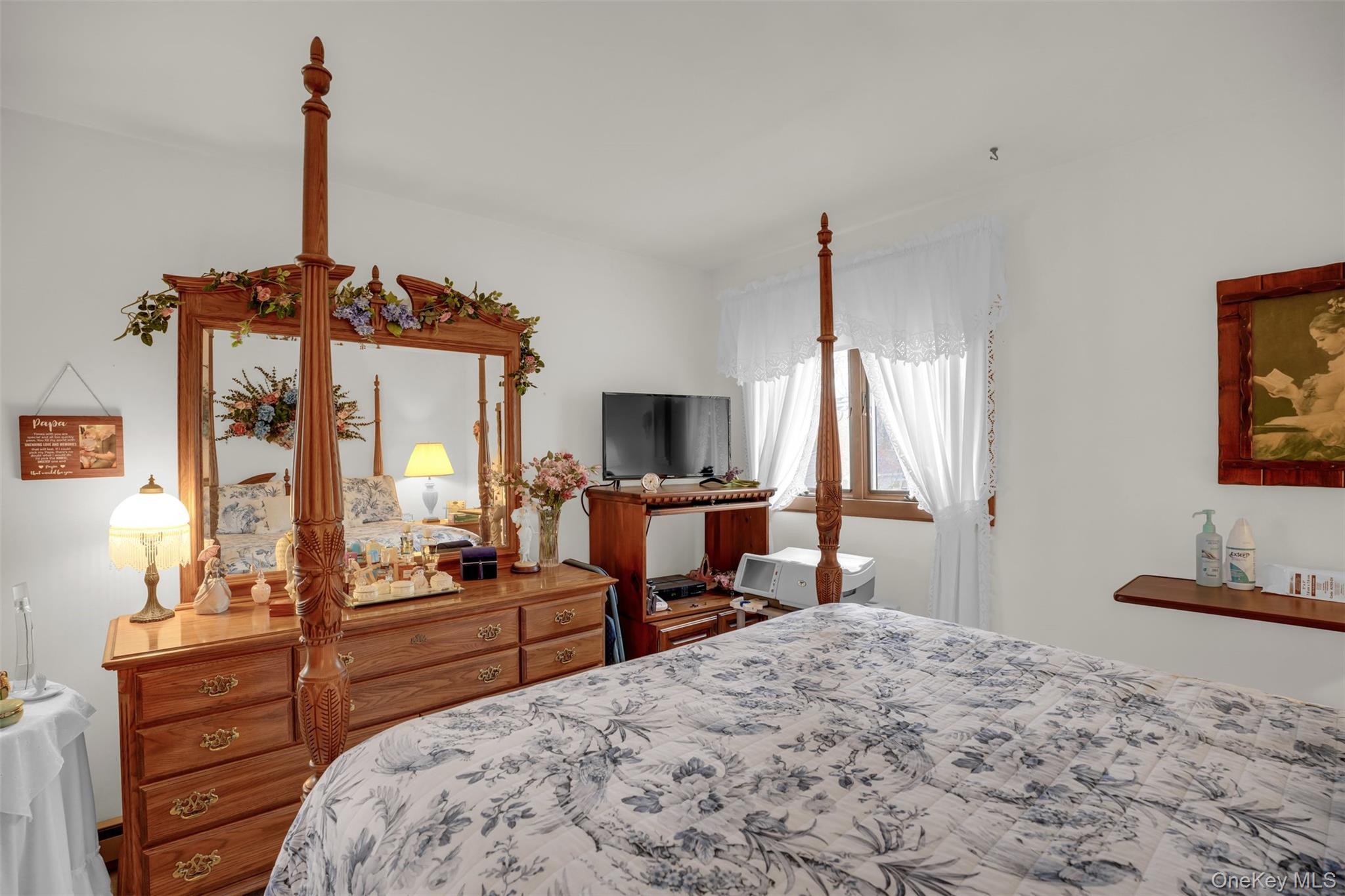 103 Wauwepex Trail Ridge, NY 11961 - Photo 21 of 25 a bedroom with a bed and a flat tv screen on dresser