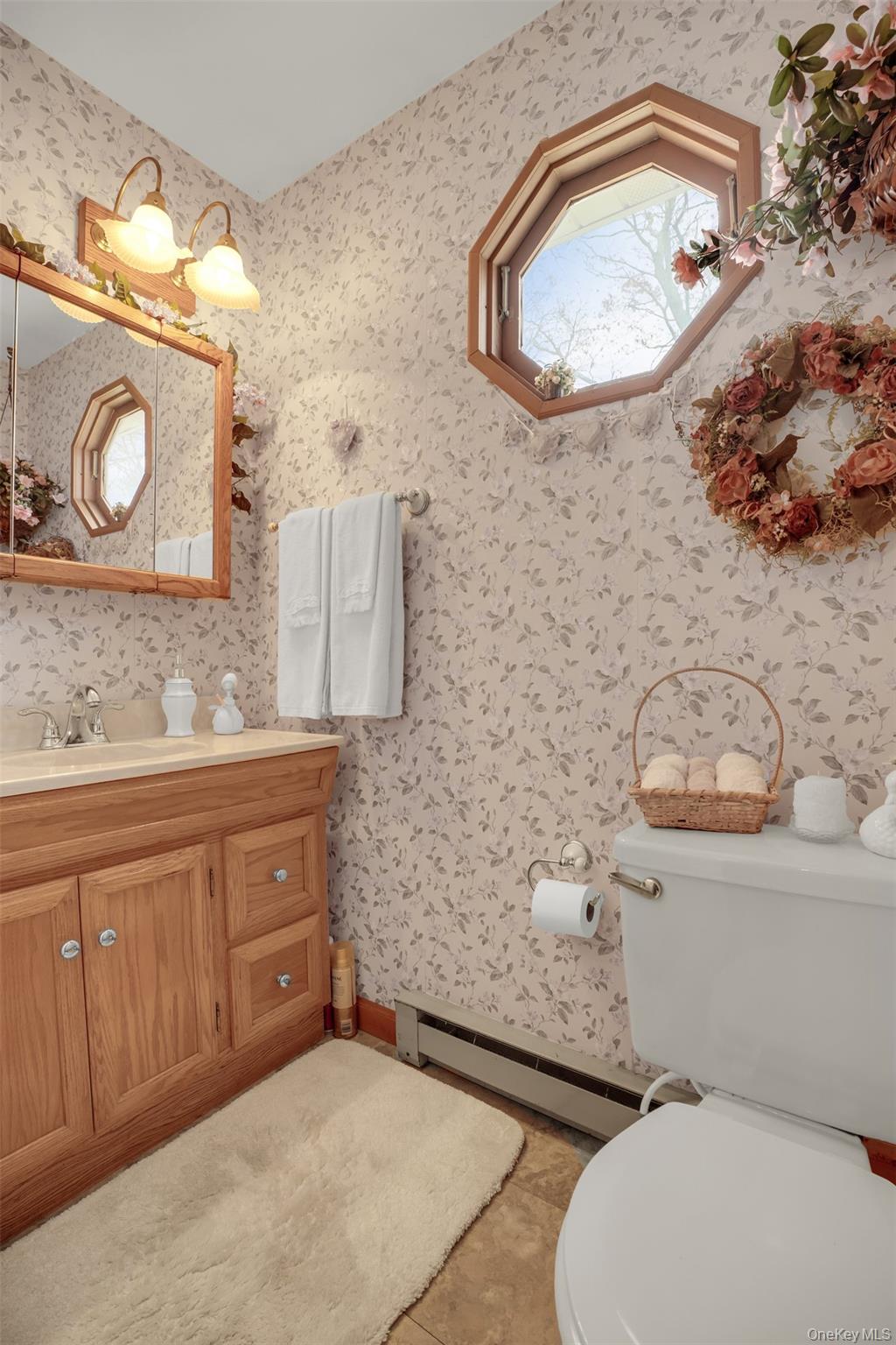 103 Wauwepex Trail Ridge, NY 11961 - Photo 22 of 25 a bathroom with a toilet a sink and mirror