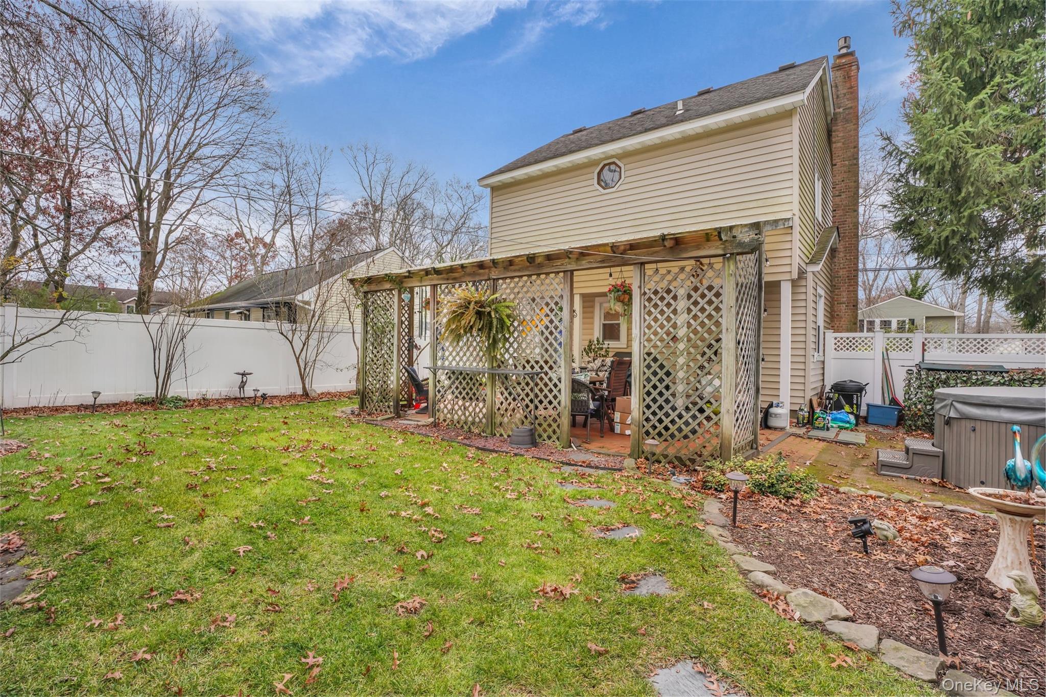 103 Wauwepex Trail Ridge, NY 11961 - Photo 24 of 25 a view of a house with backyard and garden