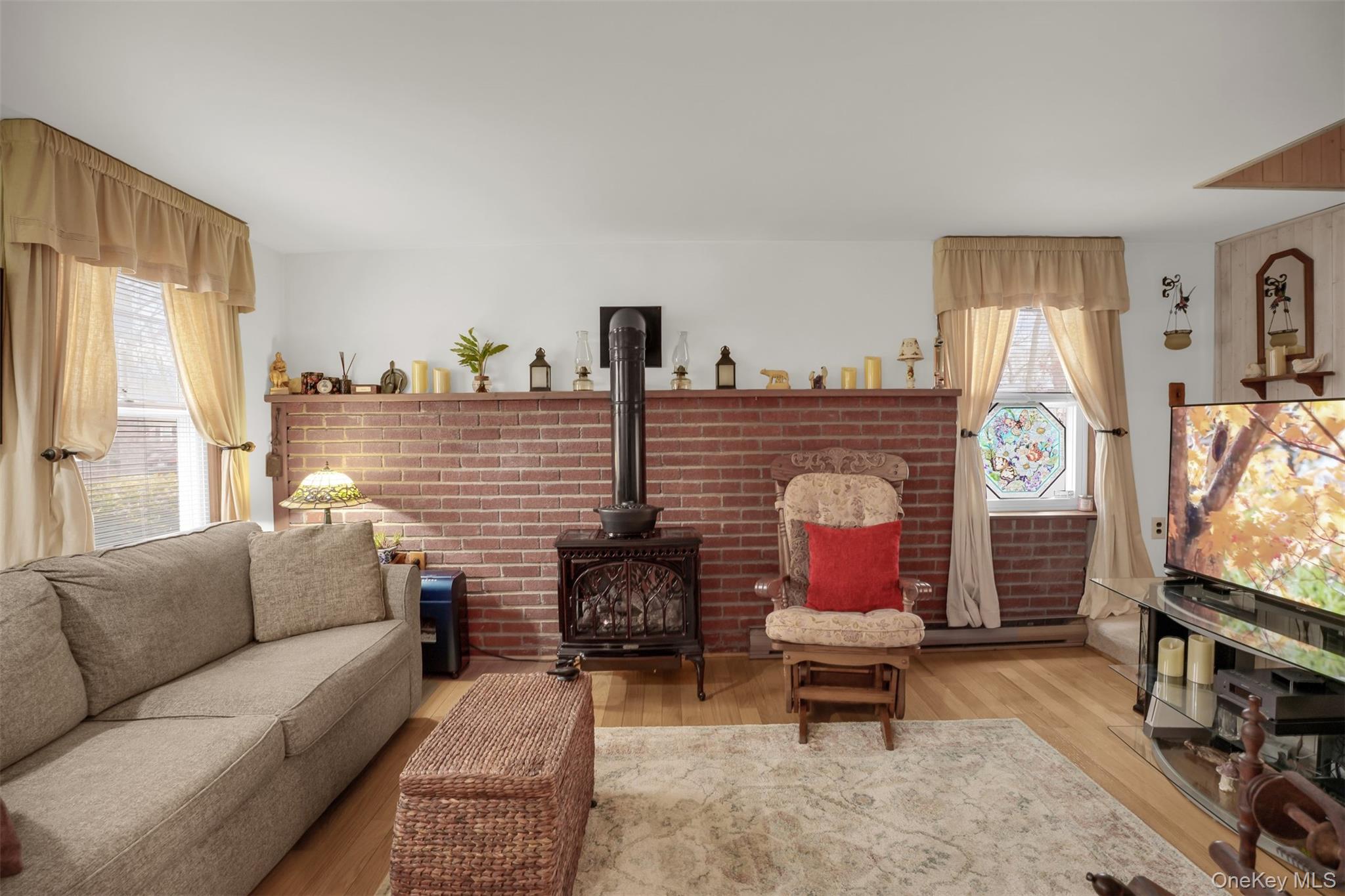 103 Wauwepex Trail Ridge, NY 11961 - Photo 4 of 25 a living room with furniture a flat screen tv and a window