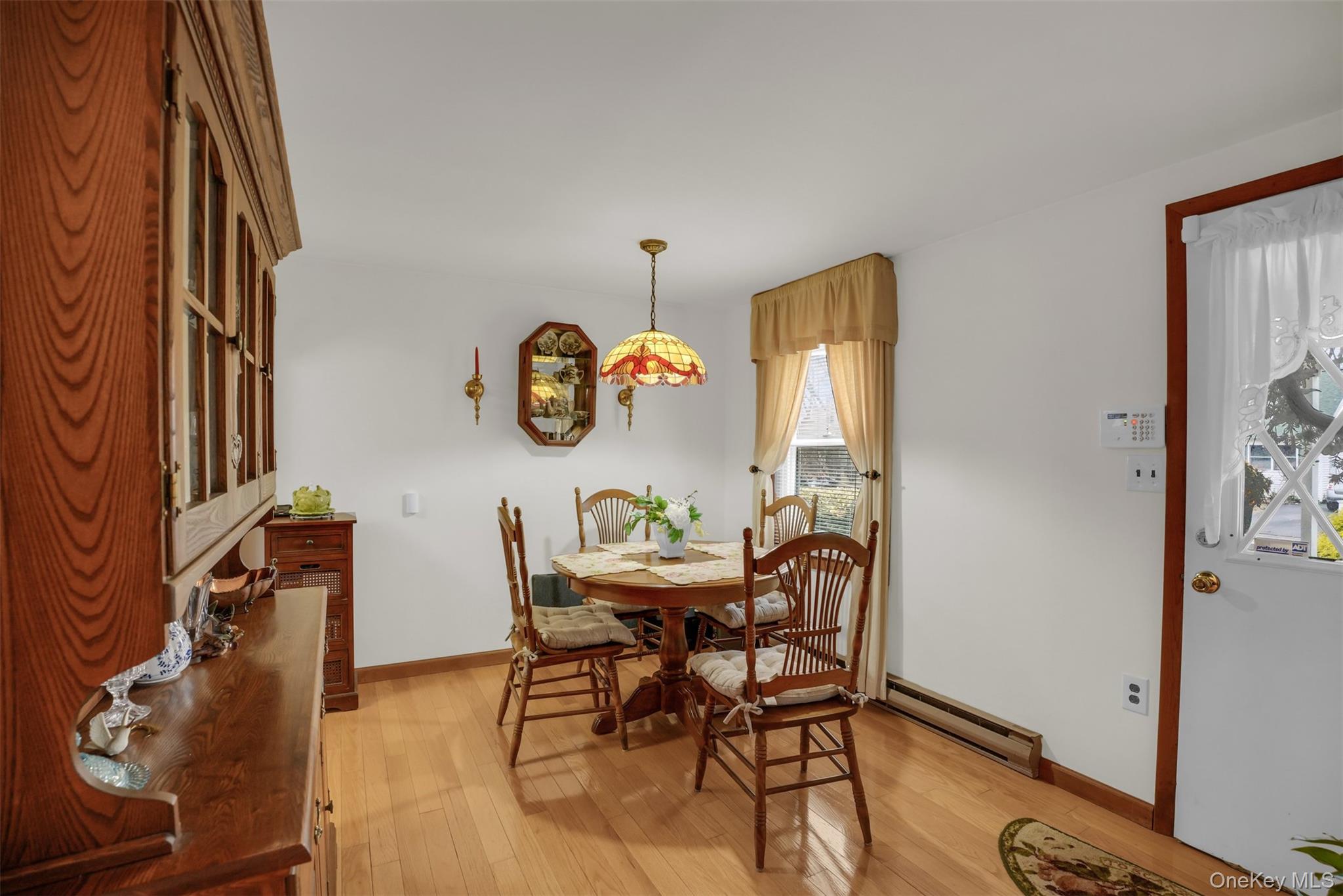103 Wauwepex Trail Ridge, NY 11961 - Photo 8 of 25 a view of a dining room with furniture and wooden floor