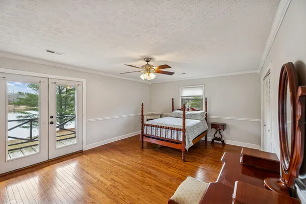 a bedroom with a bed window and a chair