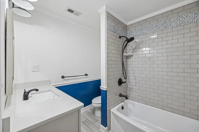 a bathroom with a bathtub and shower