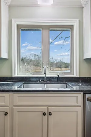 a kitchen with stainless steel appliances granite countertop a refrigerator a sink and a stove