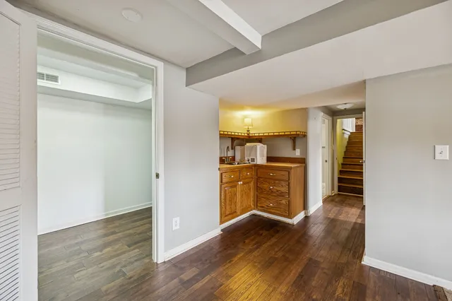 a view of a kitchen and a livingroom with wooden floor
