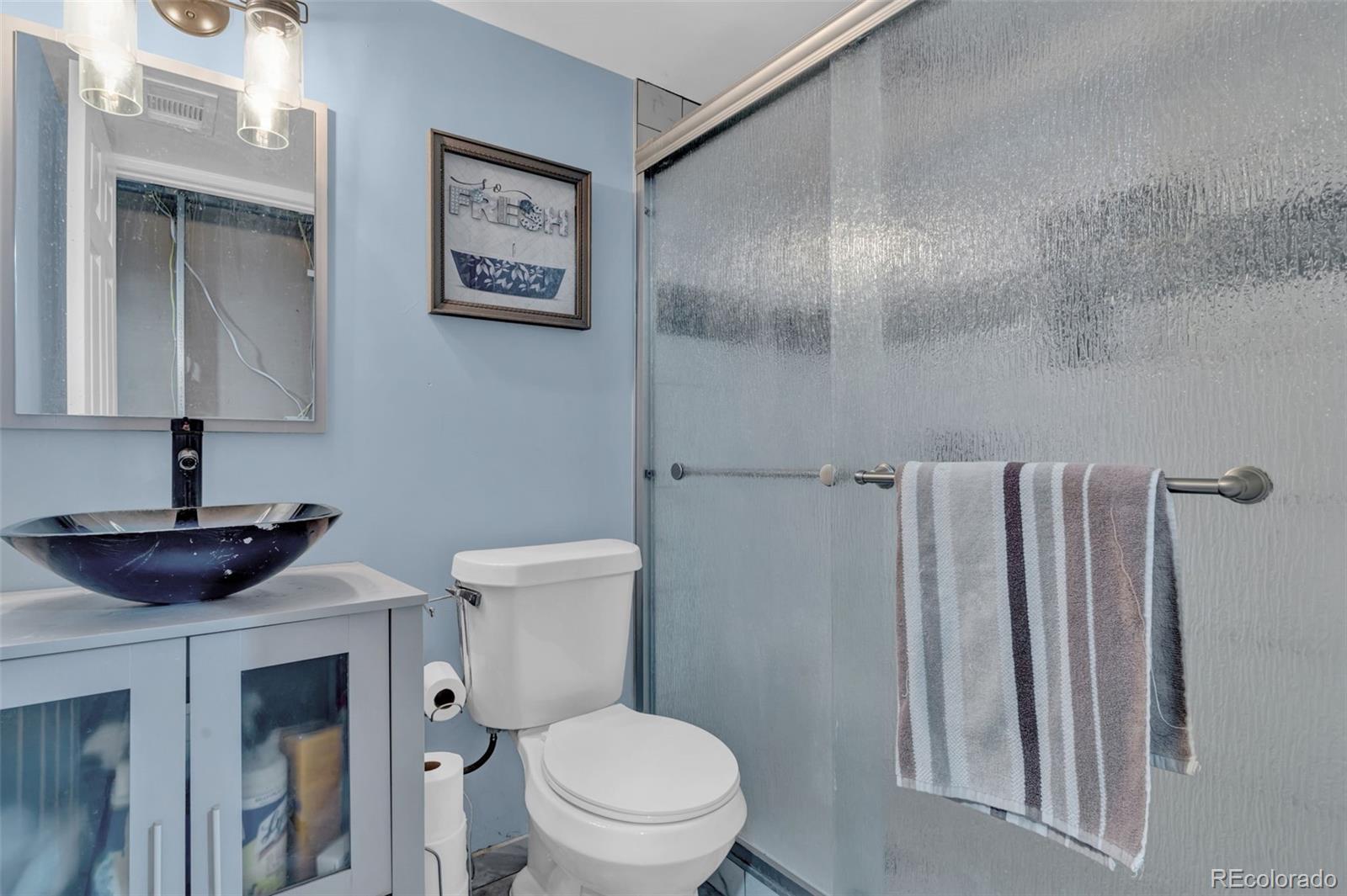 10656 Racine Circle Commerce City, CO 80022 - Photo 29 of 39 a bathroom with a toilet and a sink