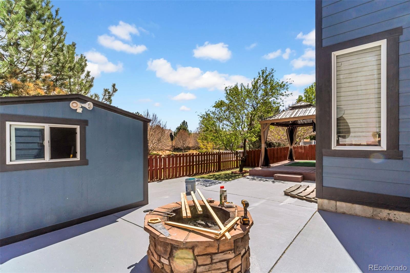 10656 Racine Circle Commerce City, CO 80022 - Photo 39 of 39 a view of a patio with a dining table and chairs with wooden floor