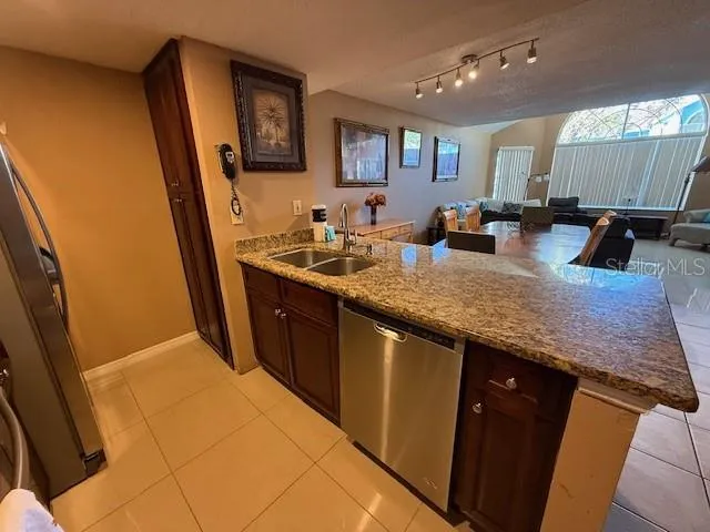 a kitchen with stainless steel appliances granite countertop a sink stove and cabinets