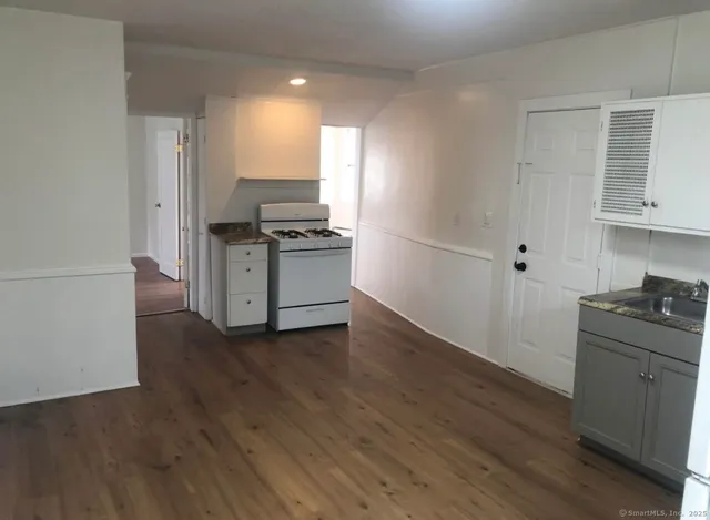 a kitchen with granite countertop a stove and a refrigerator