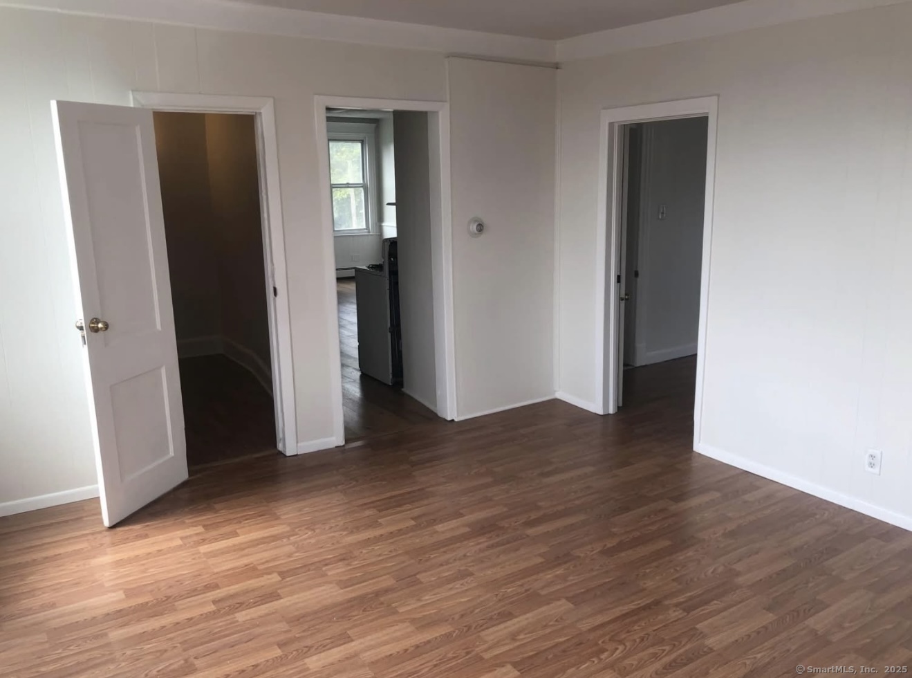 167 Chestnut Avenue, Unit 3 Waterbury, CT 06710 - Photo 6 of 10 an empty room with wooden floor and closet