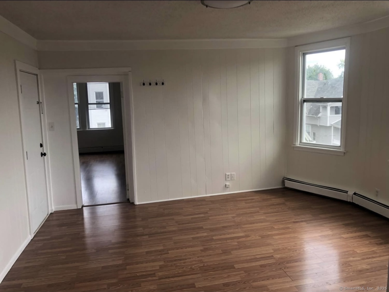 167 Chestnut Avenue, Unit 3 Waterbury, CT 06710 - Photo 10 of 10 a view of an empty room with wooden floor and a window