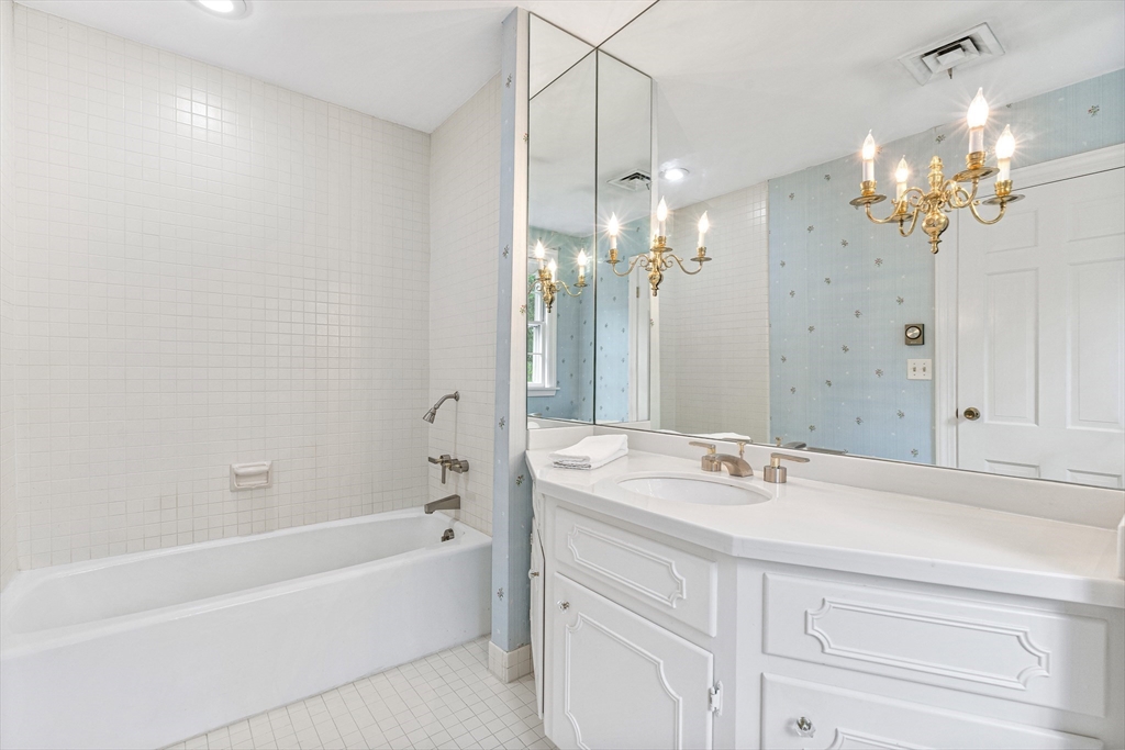 5 Deer Path Lane Weston, MA 02493 - Photo 18 of 26 a bathroom with a bathtub a sink and a mirror