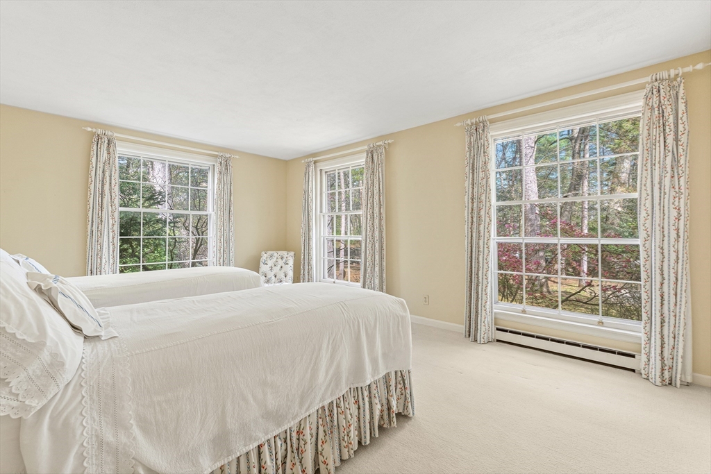 5 Deer Path Lane Weston, MA 02493 - Photo 21 of 26 a bedroom with a bed and a large window