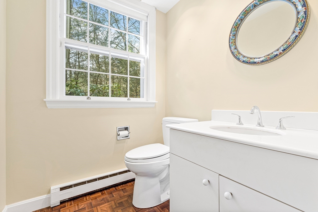 5 Deer Path Lane Weston, MA 02493 - Photo 23 of 26 a bathroom with a sink a toilet and a mirror