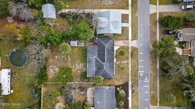 an aerial view of a residential houses with yard