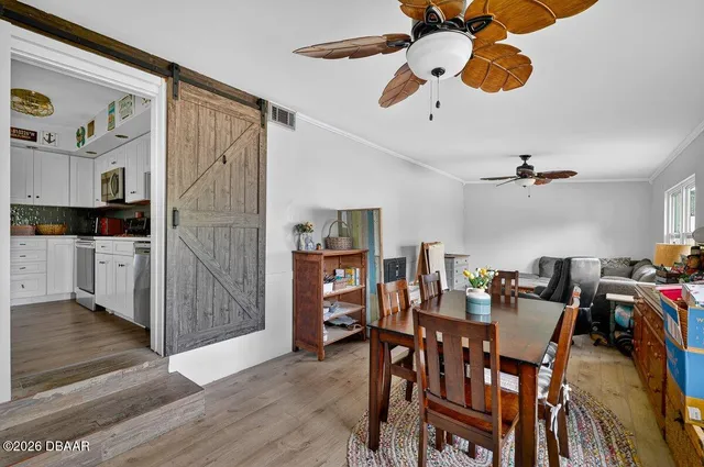 a view of a dining room with furniture and wooden floor