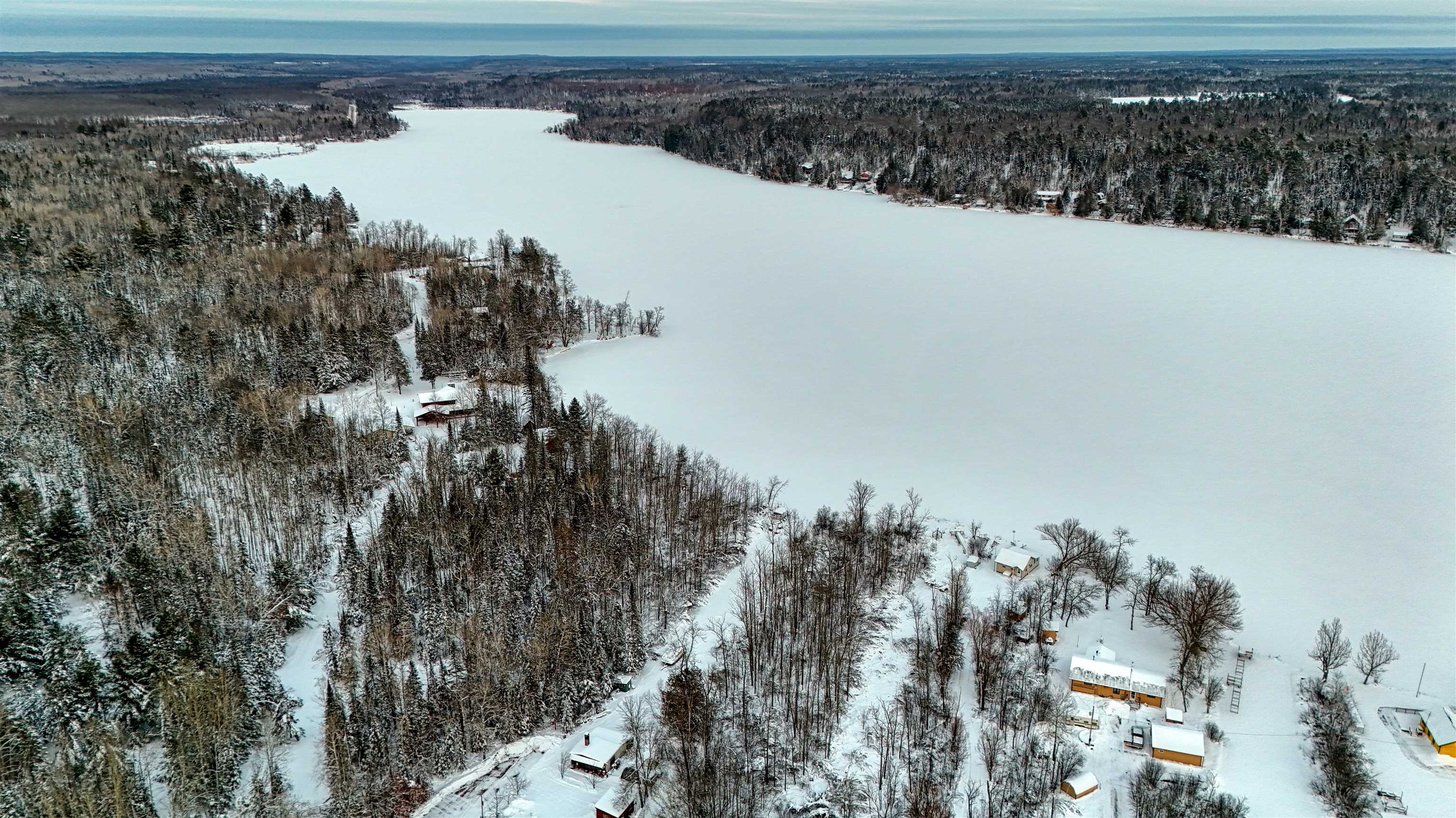 10922 South Stone Road Solon Springs, WI 54873 - Photo 13 of 64 Snowy aerial view featuring a wooded view