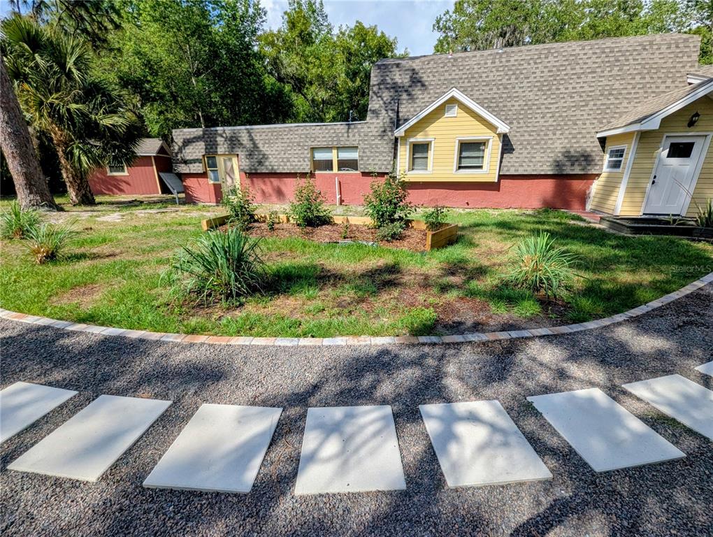 18001 Nelson Road Spring Hill, FL 34610 - Photo 1 of 29 a front view of a house with a yard and garage