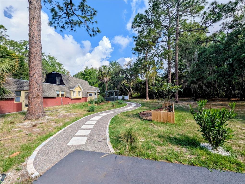 18001 Nelson Road Spring Hill, FL 34610 - Photo 2 of 29 a view of a garden with a fountain