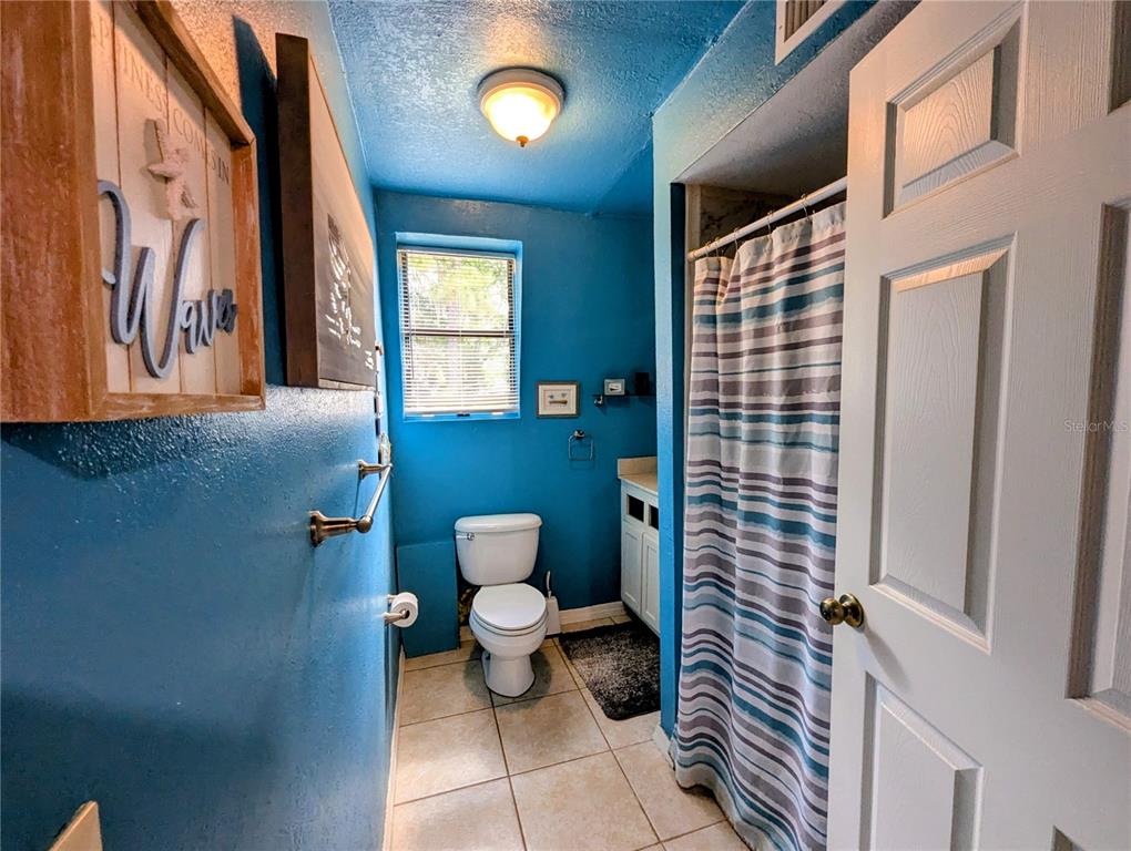 18001 Nelson Road Spring Hill, FL 34610 - Photo 21 of 29 a bathroom with a toilet and a shower curtain