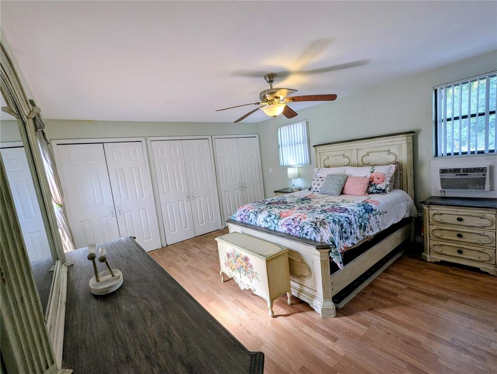 18001 Nelson Road Spring Hill, FL 34610 - Photo 24 of 29 a bedroom with a bed and a chandelier