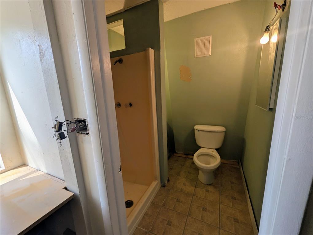 18001 Nelson Road Spring Hill, FL 34610 - Photo 28 of 29 a bathroom with a granite countertop toilet and a sink