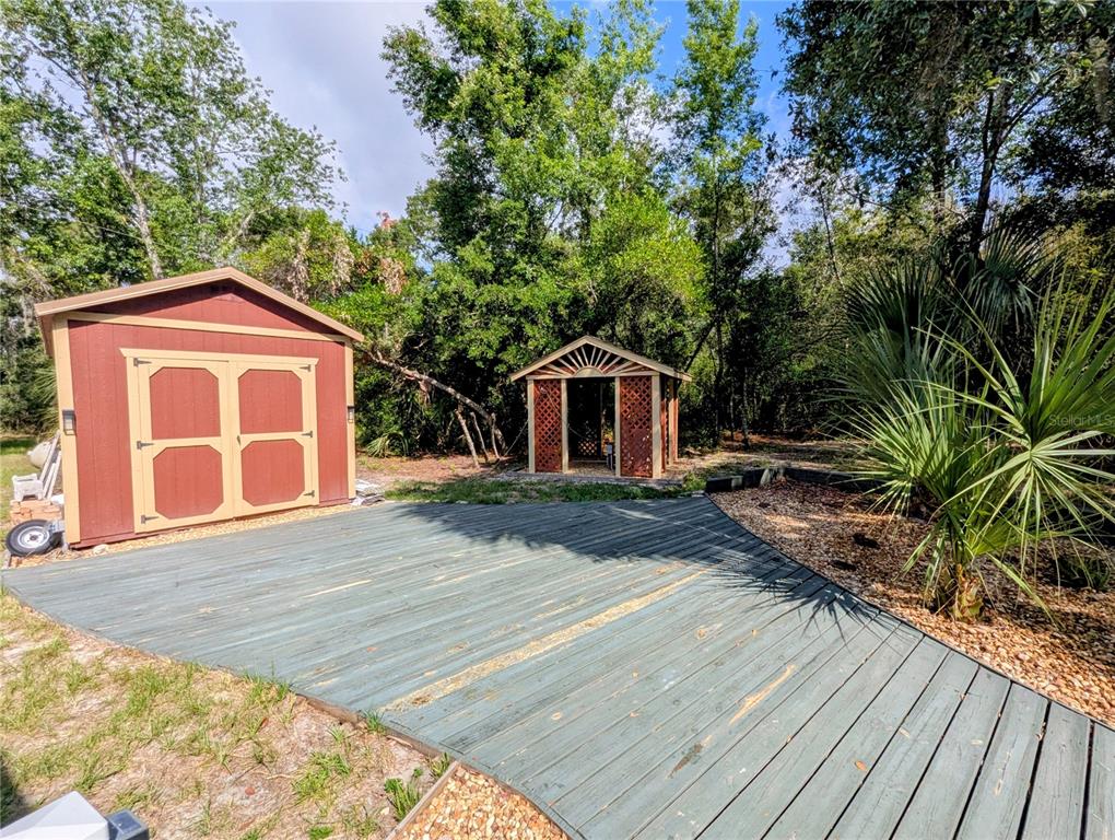 18001 Nelson Road Spring Hill, FL 34610 - Photo 7 of 29 a front view of a house with garden