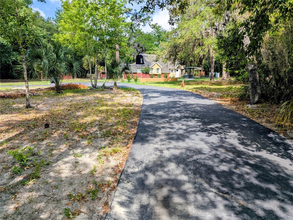 18001 Nelson Road Spring Hill, FL 34610 - Photo 8 of 29 a view of a yard with swimming pool and sitting area